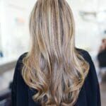 The back of a woman's hair in a salon.