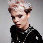 A woman with a pink and white pixie cut.