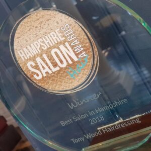 A glass award with the name of the salon on it.
