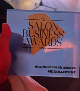 A person holds a plaque that reads, "The Salon Business Awards 2024, Business Salon 2024/25, ME Collective.